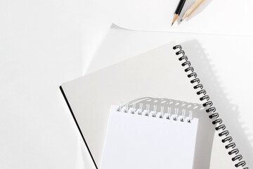 Minimalist Workspace with Spiral Notebooks, Paper and Graphite Pencils. Office Desk Flatlay, Top View.
