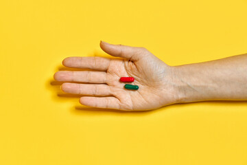 Various pills of different colors and shapes at hand