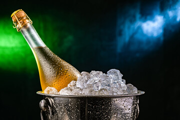 Bottle of sparkiling wine in bucket with crushed ice. © monticellllo