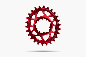 Red oval bicycle chainring against white isolated background, floating above the surface....