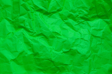 Fototapeta premium Green crumpled paper background,background shot of craft color wrinkled crumpled paper texture