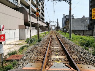 It says "Ube Shinkawa Station" in Japanese. Ube Shinkawa Station in Yamaguchi Prefecture, Japan is the station that appeared in the last scene of the movie "Evangelion: 3.0". It means that Evangelion 