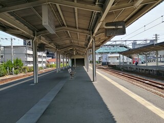 It says "Ube Shinkawa Station" in Japanese. Ube Shinkawa Station in Yamaguchi Prefecture, Japan is the station that appeared in the last scene of the movie "Evangelion: 3.0". It means that Evangelion 
