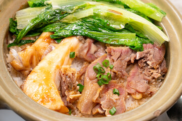 angle view clay pot rice with preserved duck and fish belly at horizontal composition