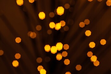 Numerous diffused lights in shades of yellow, creating a captivating bokeh effect against darkness.
