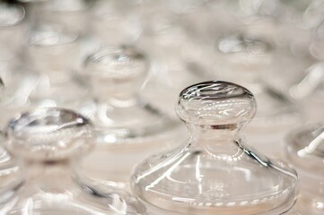A close-up shows a series of clear glass jars, beautifully arranged with an ethereal, soft focus.
