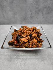 Eggplant and ground Turkey meat dish served on elegant glass plate