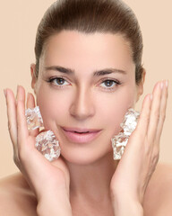 Woman practicing skincare with ice cubes on face for refreshing beauty treatment