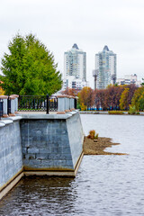 Russia, Sverdlovsk region. 24. 09. 2015. Embankment of a pond in the city on an autumn day.