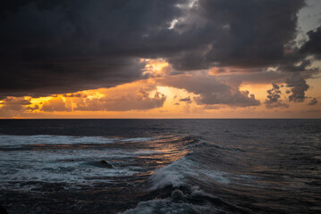 Watching the sun set by the sea