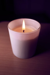 Burning white soy candle, high angle view.