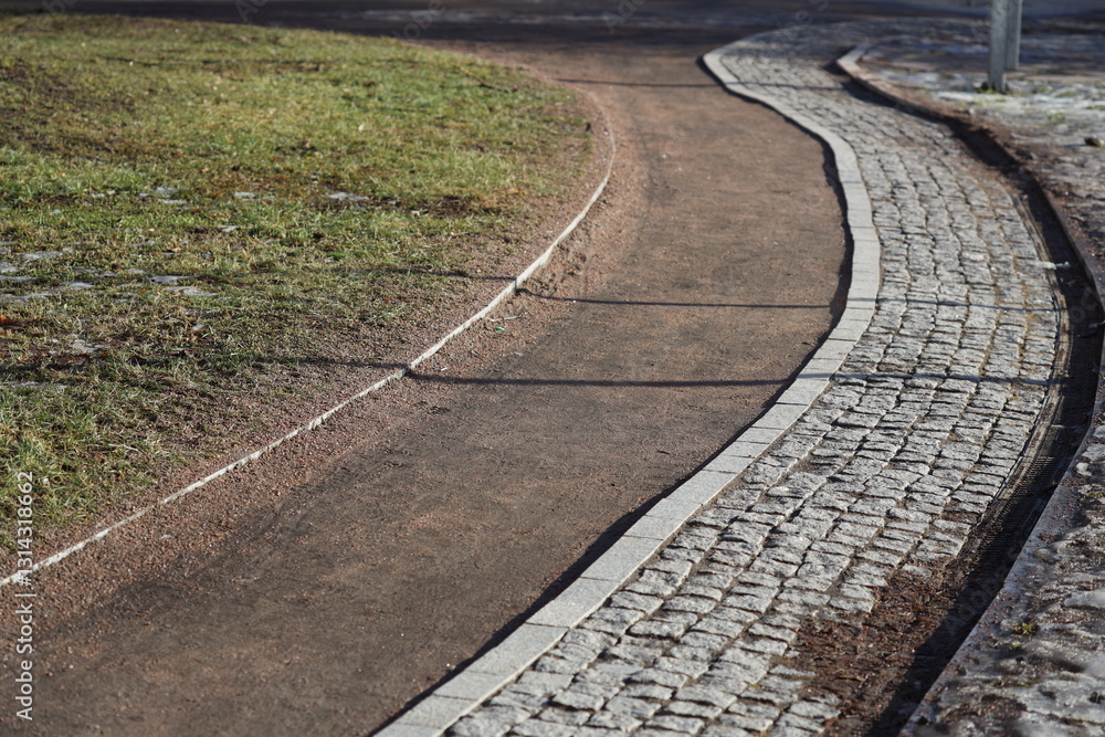 Aufkleber a clear and well-maintained pathway with a directional sign, ideal for use in travel or adventure-th