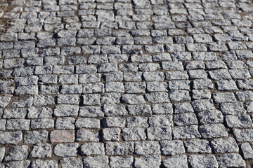 A detailed view of a worn cobblestone street.