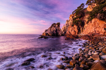 Magic sunrise at the coastline rocky beach