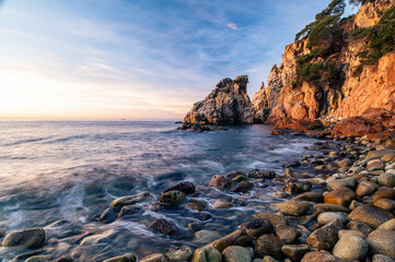 Magic sunrise at the coastline of the sea (Costa Brava, Blanes, Spain)