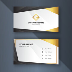 Elegant gold-trimmed business cards on dark grey background