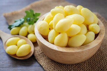 Ginkgo biloba in a wooden bowl with wooden spoon on wooden background