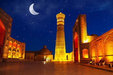 The architectural ensemble of Poi Kalyan - minaret, madrasah and mosque in beautiful illumination.