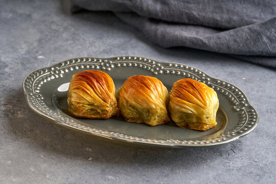 Turkish Midye Baklava with pistachio . Traditional Middle Eastern dessert . Close up	