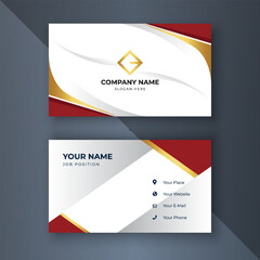 Fototapeta premium Elegant red-gold business card design on dark grey background