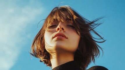Serene Beauty: A Portrait of a Woman Gazing Upward into the Azure Sky, Her Hair Dancing in the Wind, Radiating Youthful Freshness and Natural Beauty