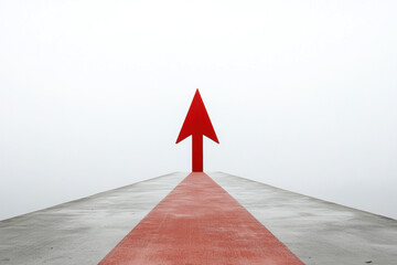 Fototapeta premium Minimalistic red arrow on a concrete surface pointing forward, symbolizing direction and progress against a neutral sky.