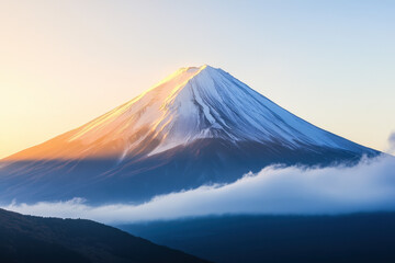 Majestic snow-capped mountain peak bathed in soft morning light with clouds at its base, showcasing a serene and picturesque natural landscape.