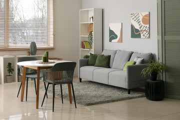 Stylish comfortable living room with sofa, table and shelving unit