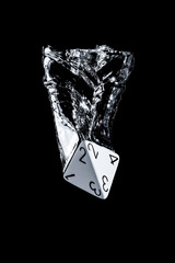 Splash photography of a 4 faces dice dropped in water with black background