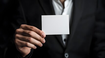 Close up of a Well Groomed Businessman s Hand Holding a Sleek Glossy White Business Card for Luxurious and Minimal Branding and Marketing
