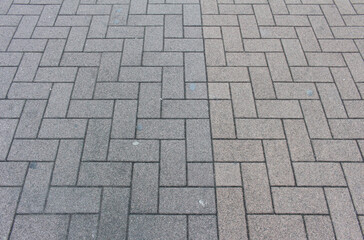 Texture of square paving tile. Pattern of gray and brown sidewalk tiles in the street. Concrete pavers close up background.	