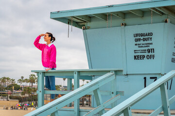 A lifeguard tower scene featuring an observer relaxing at the beautiful beach area in Santa Monica...