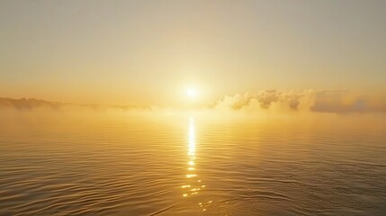Fototapeta premium Serene Sunrise Over Calm Waters with Mist and Gentle Waves