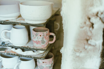 clay mugs in kiln for firing pottery