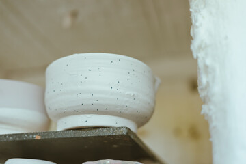 clay mugs in kiln for firing pottery