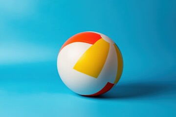 A brightly colored inflatable ball rests against a blue backdrop