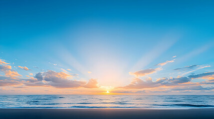 Obraz premium Golden Sunrise Over a Tranquil Ocean with Pink and Orange Clouds and Sunbeams Illuminating the Calm Blue Water with Gentle Waves on Sandy Beach
