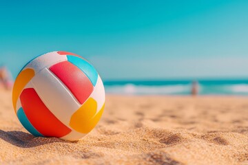 Obraz premium Colorful Beach Volleyball on Sandy Shore with Ocean and Sky in Background