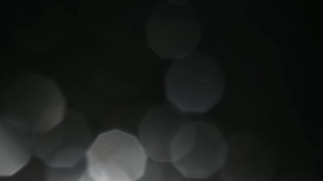 A mystical and mysterious atmosphere from the light of a flashlight on the front lens of the objective, where dust particles and water drops shimmer as bokeh in this light.