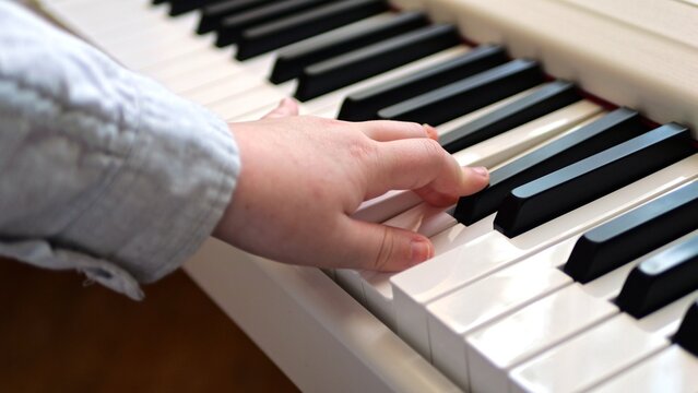 Children's hands on piano keys