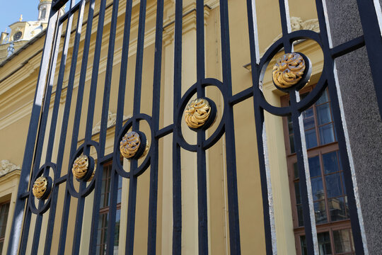 Gilding elements of wrought iron gates in a palace in St. Petersburg