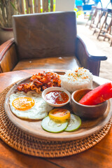 Delicious filipino breakfast with bacon, eggs, and rice in siargao island