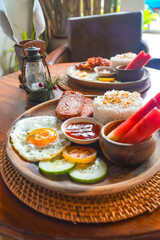 Enjoying filipino breakfast with rice, egg, and watermelon in siargao island