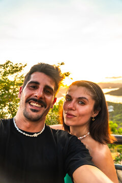 Tourists taking selfie at mount tapyas sunset in coron, philippines