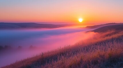 Sunrise over misty hills