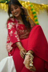 woman in red dress. Beautiful Henna on legs of indian bride in red. wedding legs jewellery. Indian bride Mehendi Ceremony. Henna art tattoo wedding design. Wedding Henna. Wedding Mehendi.