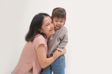 A joyful moment between a mother and her child, capturing love and togetherness in a light, minimalistic setting, highlighting familial bonds.