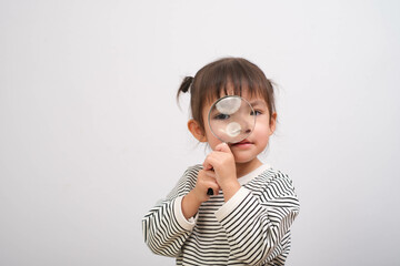 Adorable child with magnifying glass explores the world. Curiosity and discovery in a playful moment, showcasing wonder and imagination.