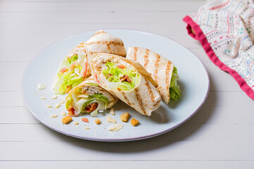 Turkey wraps on a plate. Tortilla, burritos, sandwiches, twisted rolls