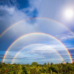 a rare triple rainbow in the sky